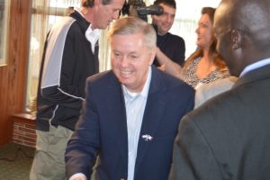 Graham shakes hands after his speech