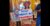 Photo is of signs held by two women at the protest of the 2023 near-total abortion ban. Both are in the Capitol Rotunda. The woman in the center is wearing a hat and smiling over her sign that reads "what about my heartbeat." On the left, just behind her, is a woman in a jean jacket who is also smiling and holding a sign that reads "Our liberties we prize and our rights we will maintain." The words are around an illustration of a uterus that's surrounded by flowers.