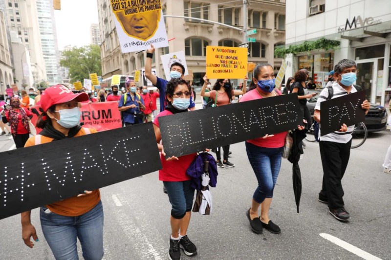 People participate in a "March on Billionaires" event on July 17, 2020 in New York City. The march, which included a diverse group of activists, politicians and citizens, called on New York Governor Andrew Cuomo to pass a tax on billionaires and to fund workers excluded from unemployment and federal aid programs. Joining the marchers were dozens of taxis whose drivers have been especially impacted by the drop ridership due to Covid-19. According to data from the Organization for Economic Cooperation and Development, income inequality in the United States is the highest of all G7 nations. (Photo by Spencer Platt/Getty Images)