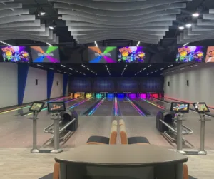 A small bowling alley is lit up with neon lights for glow bowling.