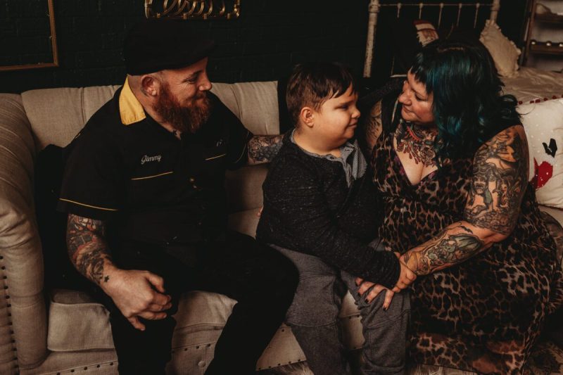 Abram Miller, 11, center, hugs his mom, Erin Farquhar, at right, as James Farquhar sits at left. Abram takes CBD medication from Colorado to control his seizures and behavior issues. Now, that medication is illegal for anyone under 21 to consume. (Courtesy Erin Farquhar)