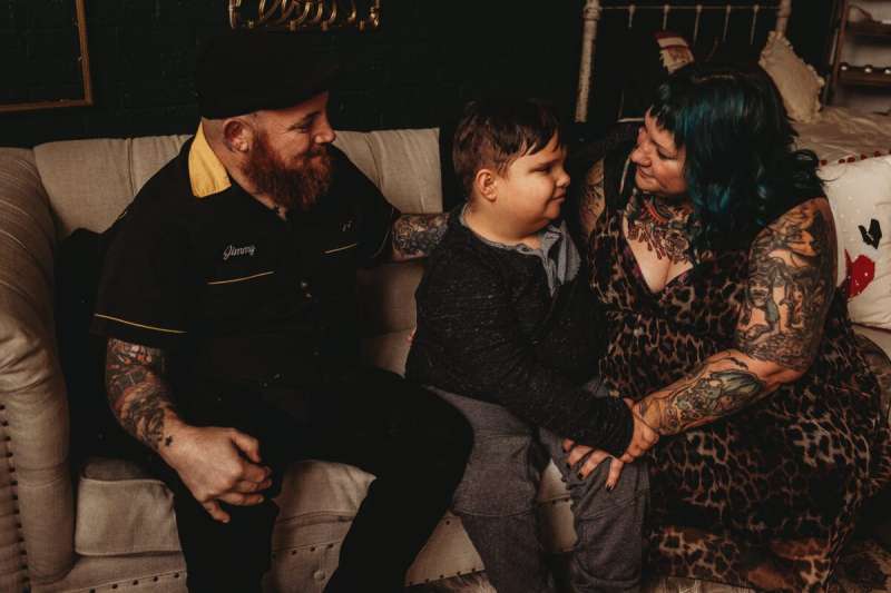 Abram Miller, 11, center, hugs his mom, Erin Farquhar, at right, as James Farquhar sits at left. Abram takes CBD medication from Colorado to control his seizures and behavior issues. Now, that medication is illegal for anyone under 21 to consume. (Courtesy Erin Farquhar)