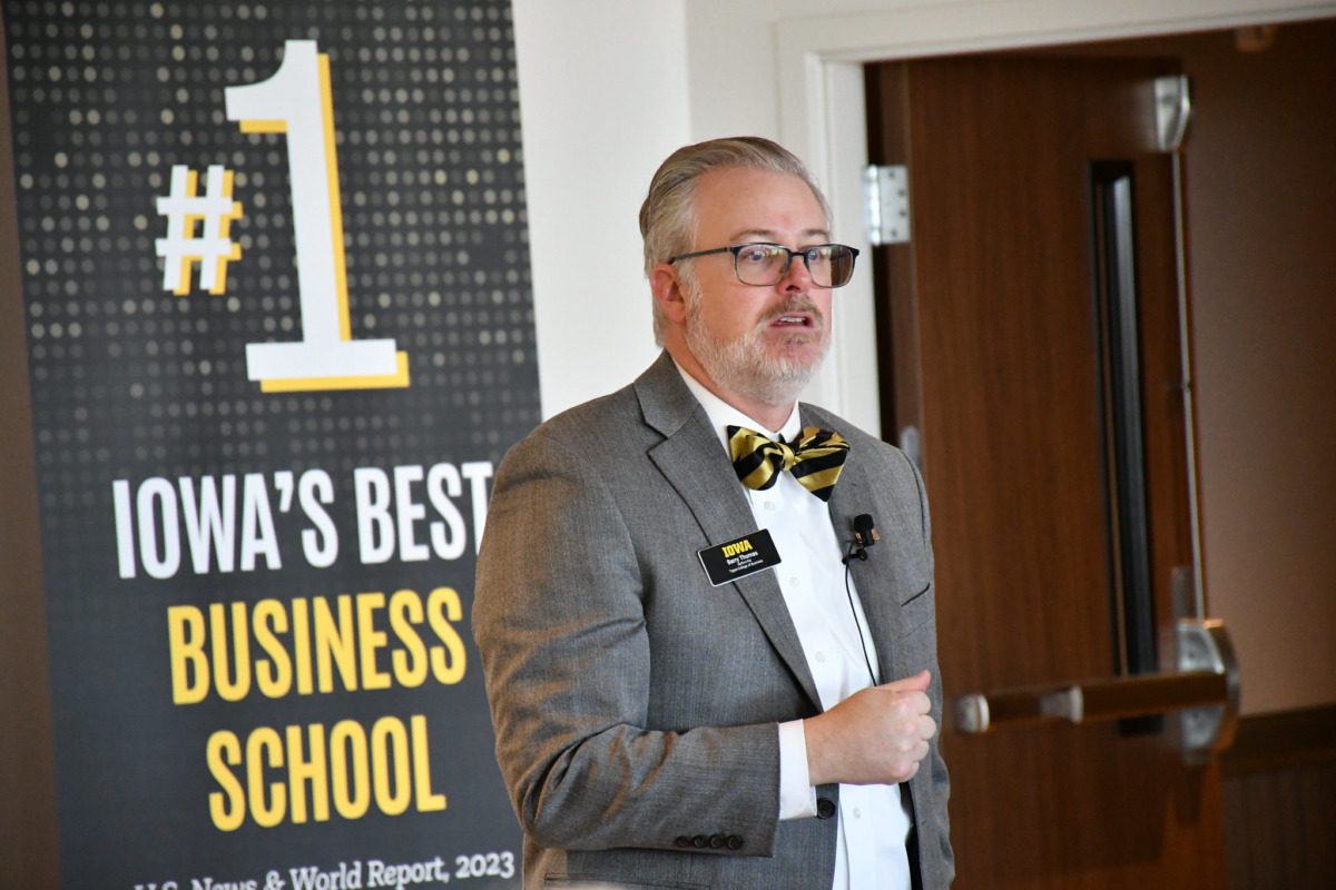 Man in suit speaking at a campus event.