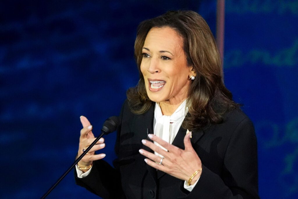 Kamala Harris at the podium speaking at the debate. She's gesturing.