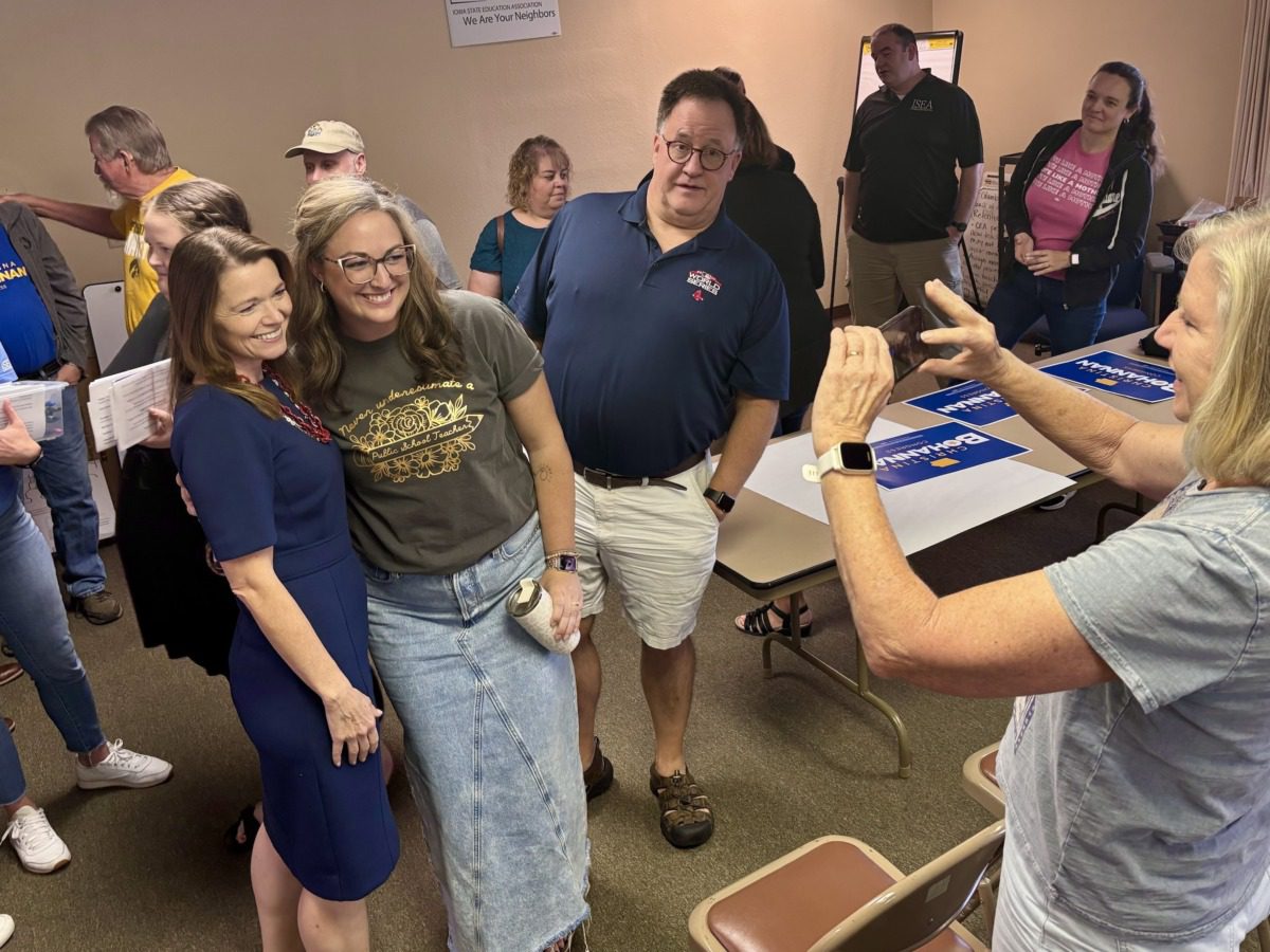 Democratic candidate Christina Bohannan takes a selfie with a supporter at a town hall organized by Iowa State Education Association.