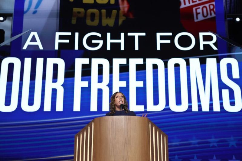 Jessica Mackler speaks at podium with the text "A fight for your freedoms" projected across the top. Her group EMILYs List works to elect Democratic pro-choice women who will protect rights to an abortion.