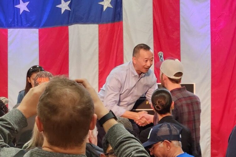 Democratic candidate Lanon Baccam shakes a supporter's hand at the close of his Monday rally.