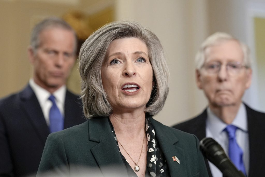 US Sen. Joni Ernst of Iowa stands next to Sen. Minority Leader Mitch McConnell of Kentucky.