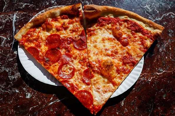 A fresh slice of pepperoni and cheese pizza