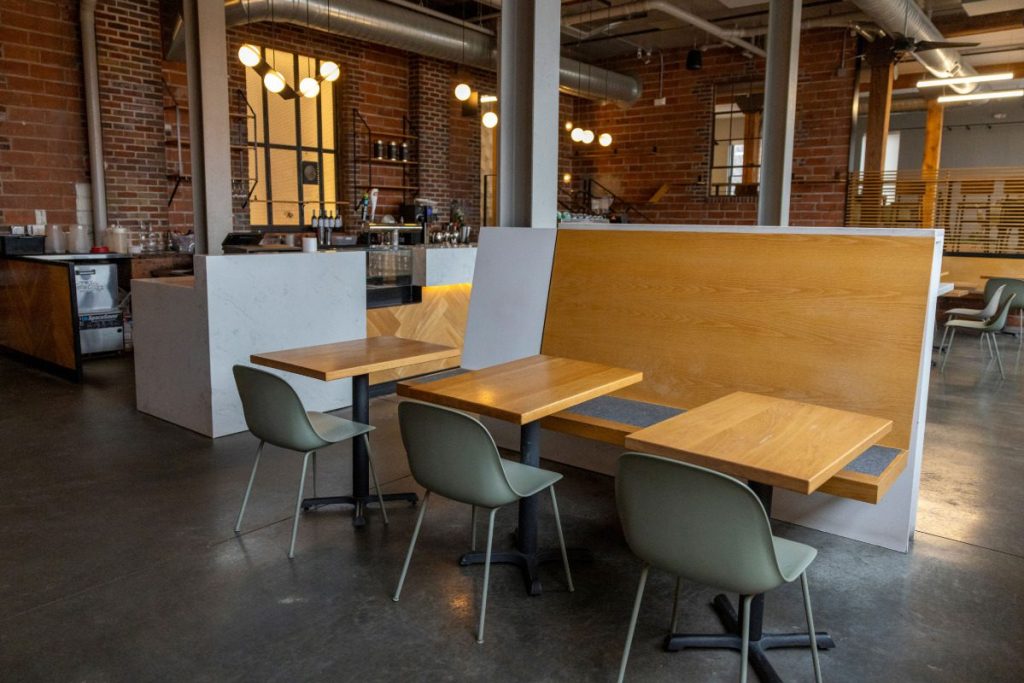 A view of the inside of the gaming lounge, showing the front counter and some small tables