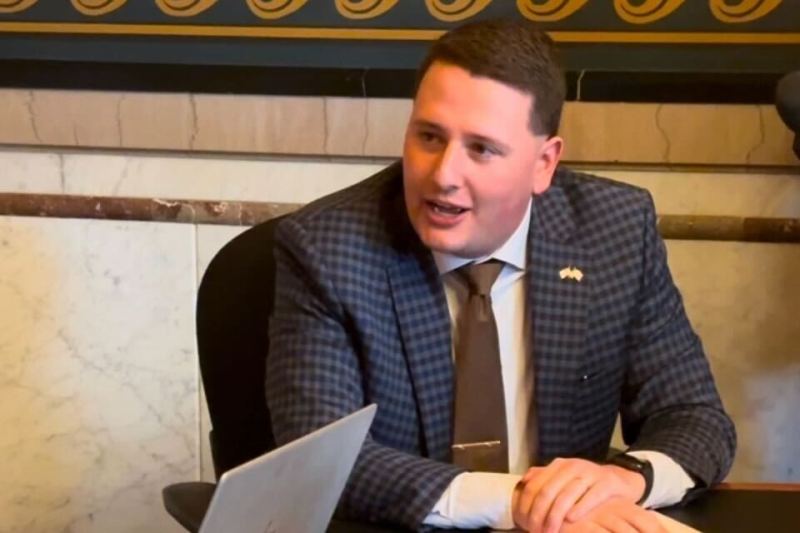 Republican state Rep. Taylor Collins of Mediapolis sits at a table in the Iowa House Lounge.