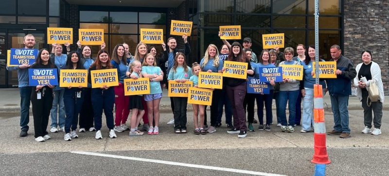River Hills Community Health Care workers hold up signs as they announce their unionization effort outside of their Ottumwa clinic on May 28, 2025. (Photo courtesy Teamsters Local 90)