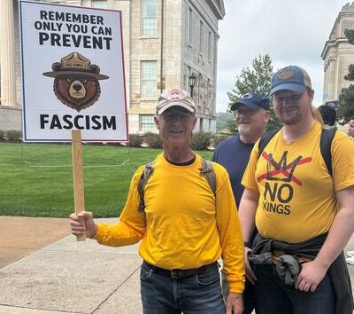 Two No Kings protesters pose with a sign saying "Only you can prevent fascism" on Oct. 18, 2025, in Iowa City. (Zachary Oren Smith / Iowa Starting Line)