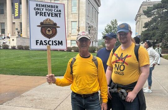Two No Kings protesters pose with a sign saying "Only you can prevent fascism" on Oct. 18, 2025, in Iowa City. (Zachary Oren Smith / Iowa Starting Line)