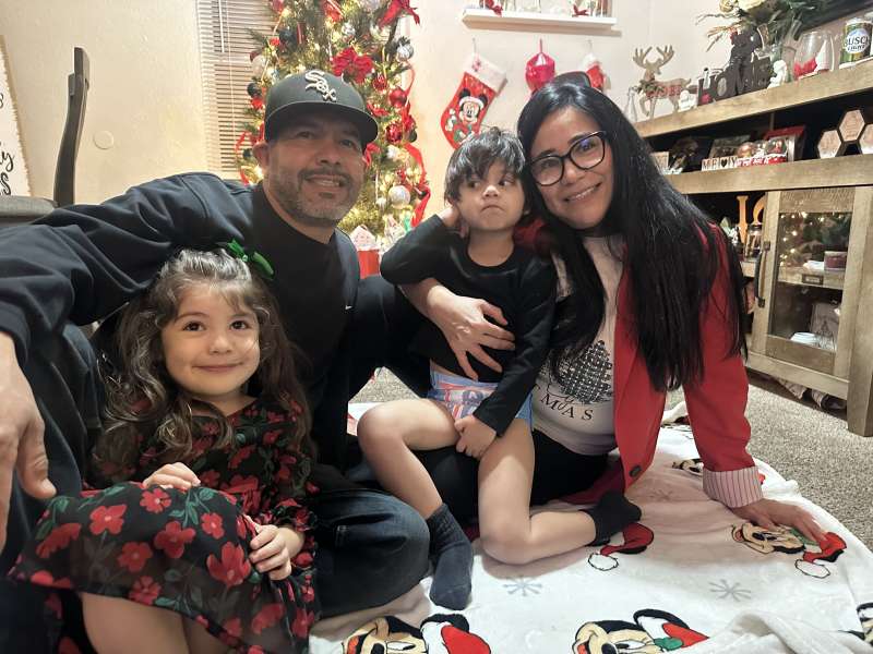 Juan Lopez, upper left, with his longtime partner Laura Becerra and two of their grandchildren pose in this undated photo from Lopez' family. (Courtesy Escucha Mi Voz)